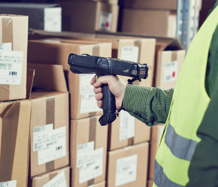 Warehouse worker with RF barcode scanner, using Warehouse Management System