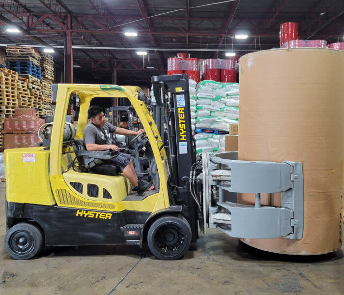 Axis Warehouse Worker Operating Hyster Roll Handling Forklift with Paper Clamp Attachment