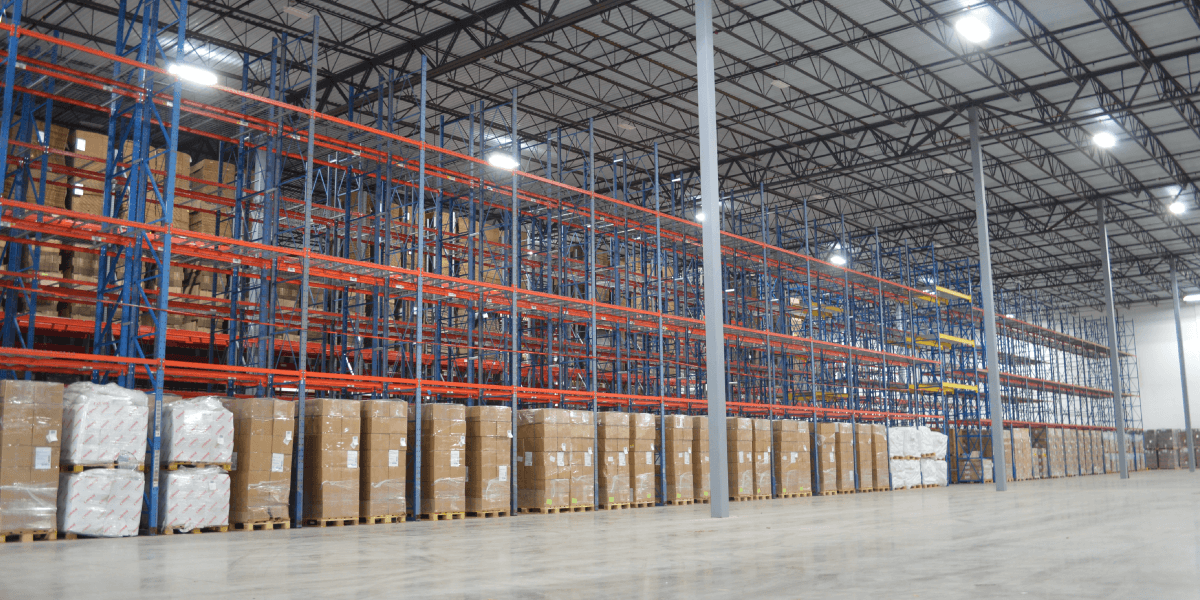Warehouse interior with shelves, pallets and boxes