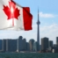 Canadian flag is waving front of Toronto City view