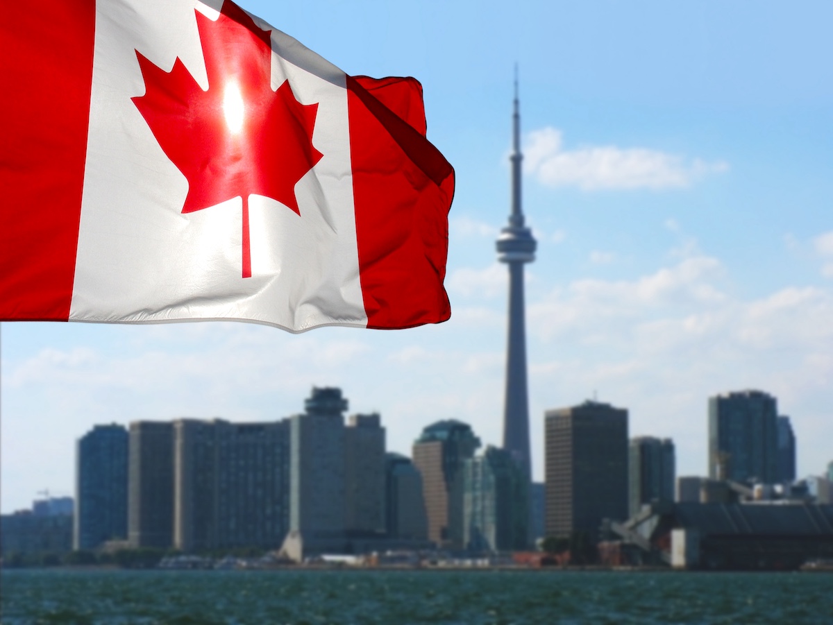Canadian flag is waving front of Toronto City view