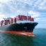Aerial side view of cargo ship carrying container and running for export cargo yard port to custom ocean concept technology transportation , customs clearance, webinar banner forwarder mast